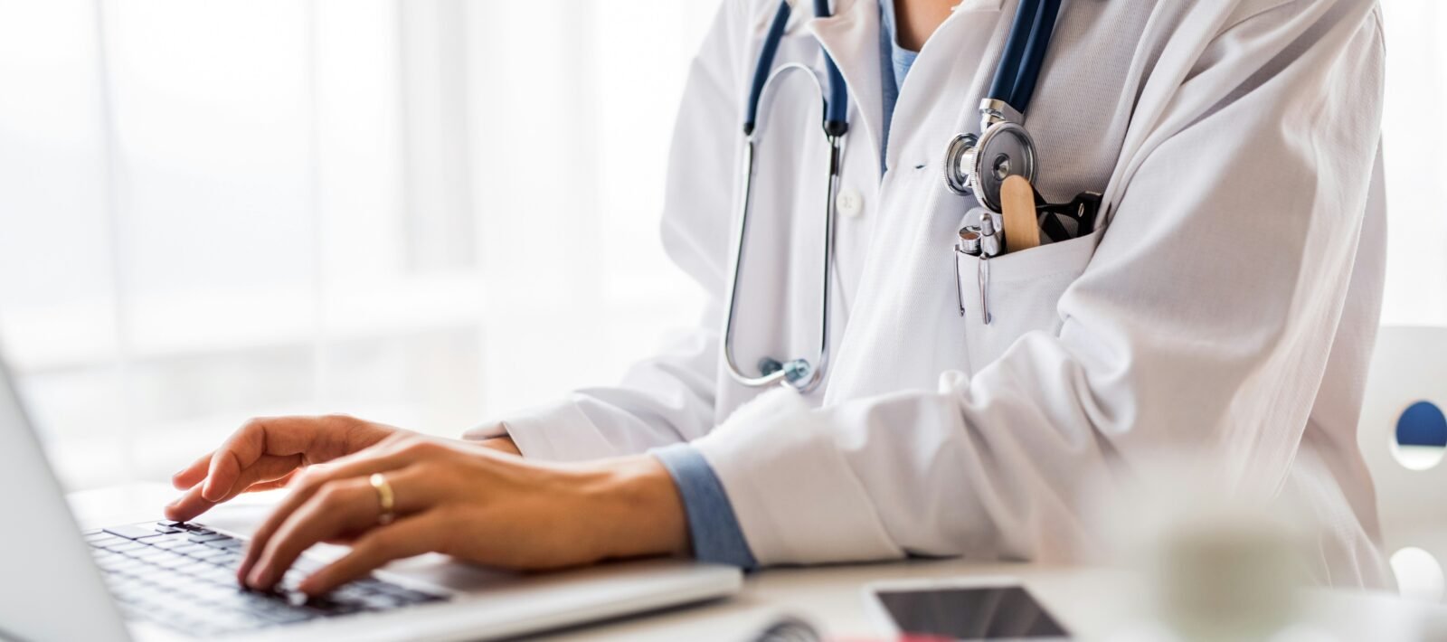 Doctor typing on computer
