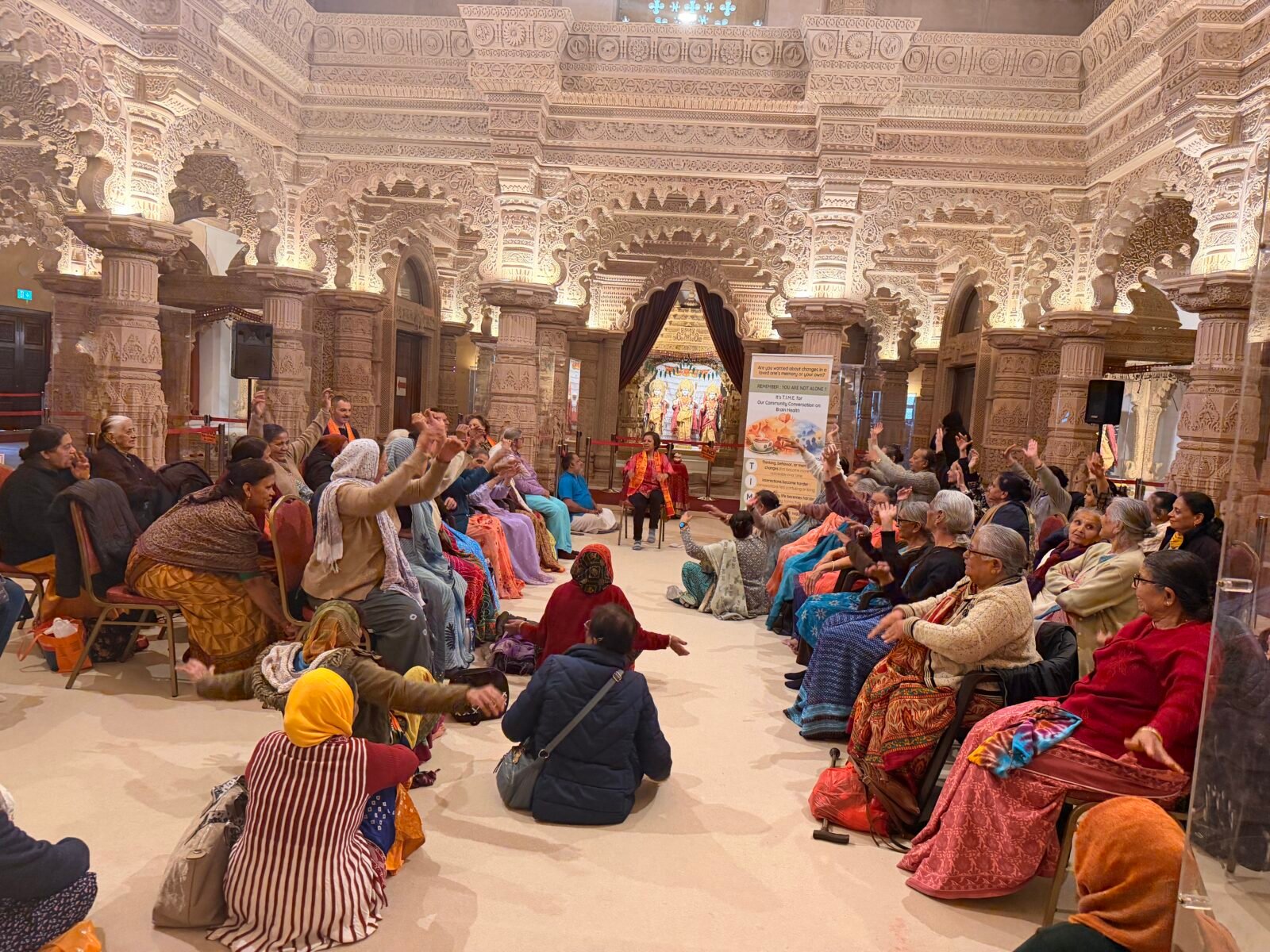 People in temple listening to presentation